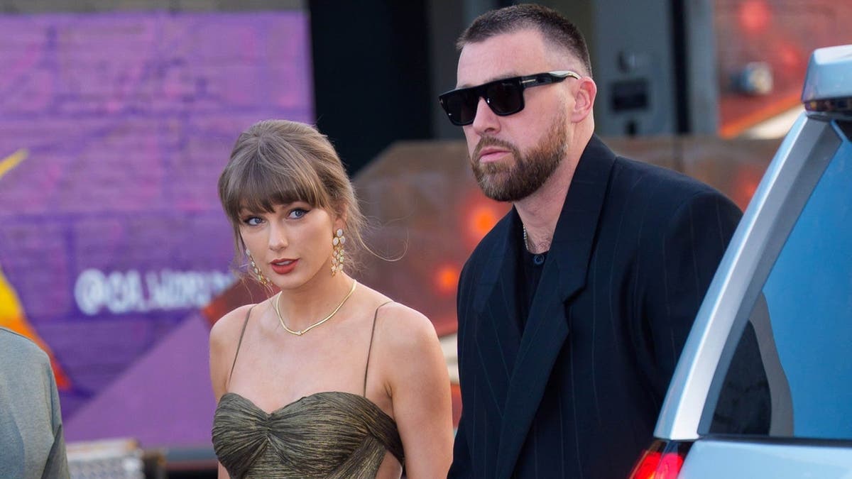 Taylor Swift and Travis Kelce standing together in New York City.