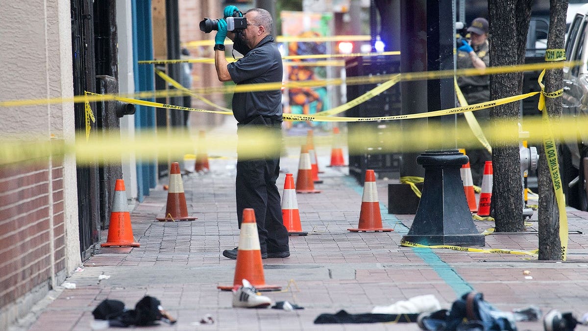 Forensics photographer takes photo of crime scene