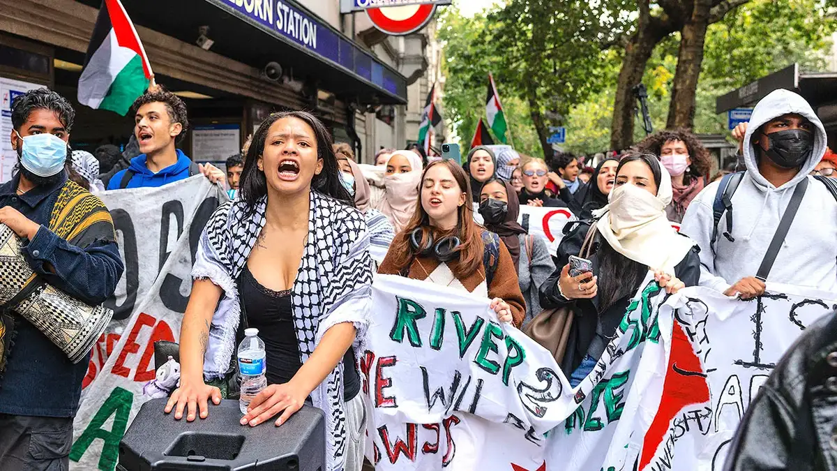 Protesters from London universities marching in central London holding pro-Palestine signs