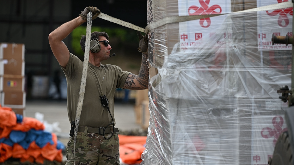 A U.S. soldier undoes wrapping on Chinese aid to Venezuela