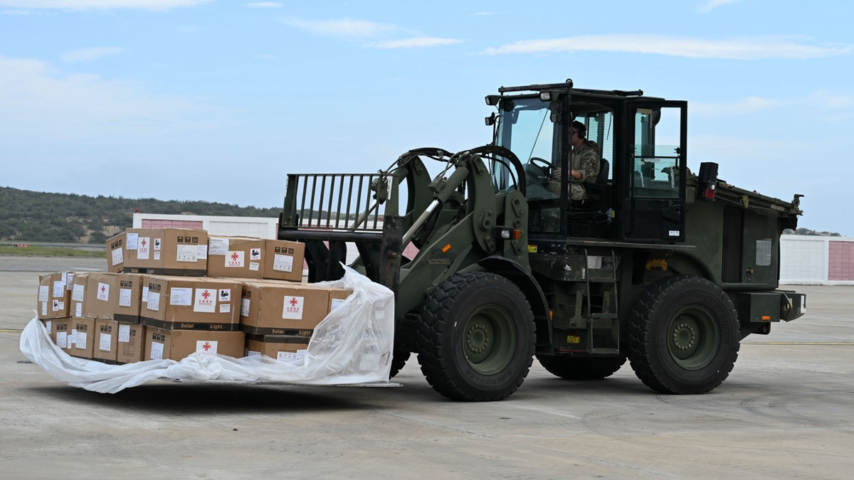 U.S soldier drives a wheel loader