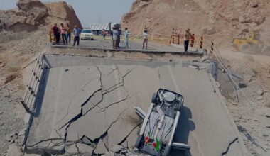 An overturned car sits on a section of a destroyed bridge after a strike in Hormozgan province, southern Iran, Saturday, July 18, 2026. (Mahdi Negahban/Mehr News Agency via AP)