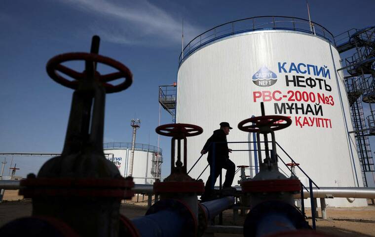 REUTERS/PAVEL MIKHEYEV/FILE PHOTO
A worker walks near storage tanks at the Airankol oil field operated by Caspiy Neft in the Atyrau region, Kazakhstan, on April 20. Oil prices climbed about 2% today to a five-week high on worries that energy supply disruptions could worsen in the Middle East due to more attacks between the U.S. and Iran and a threatened naval blockade of Saudi Arabia by Yemens Houthis.