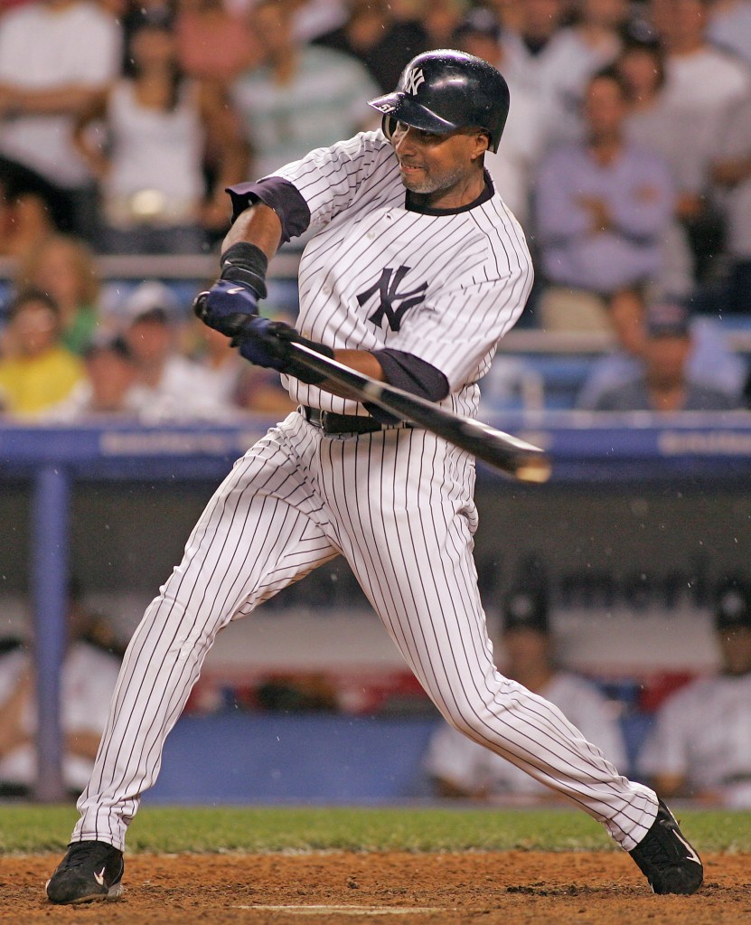 Bernie Williams, a Yankees player, mid-swing with a baseball bat.