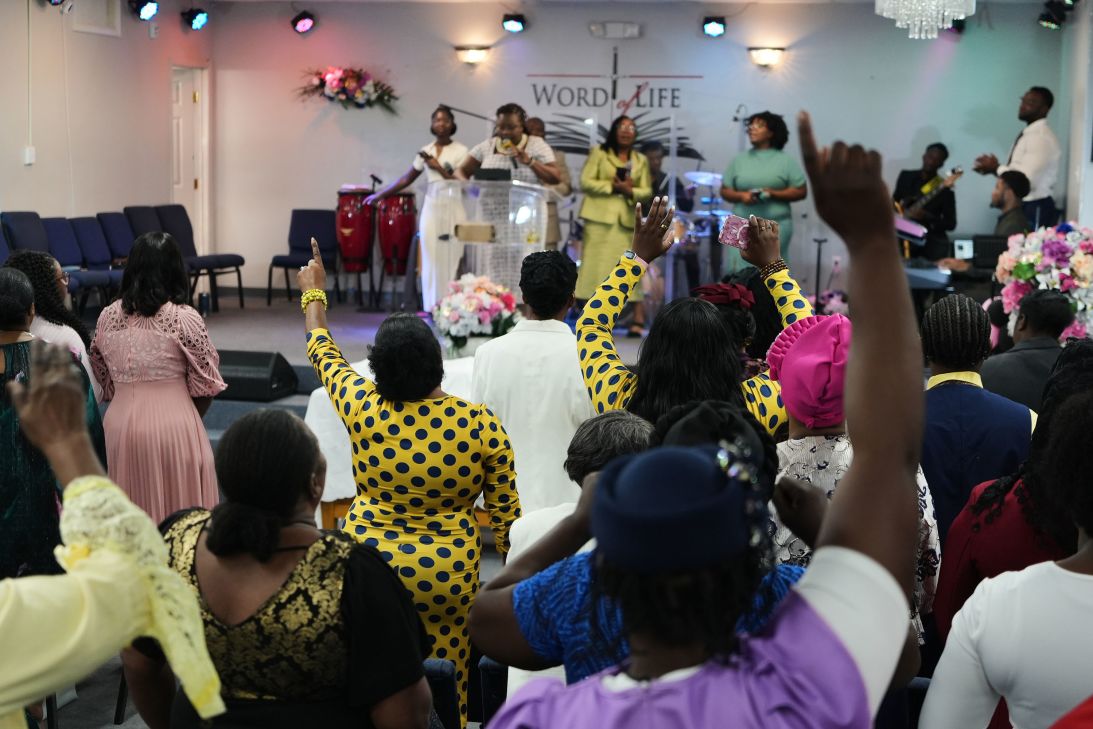 Members of the Word of Life Center, a church and hub of the Haitian community, sing and pray August 2 during a service in Salisbury, Maryland.