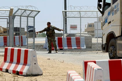 A U.S. soldier opens the entrance to the LSA Endurance, a logistical support and staging facility designed to support the International Stabilization Force (ISF) under the direction of the Board of Peace (BoP), near the Israel-Gaza border in the Kerem Shalom area, southern Israel, August 10, 2026.