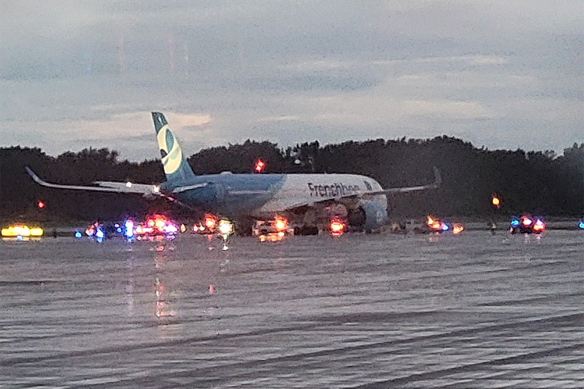 A French bee jet on the tarmac surrounded by emergency vehicles