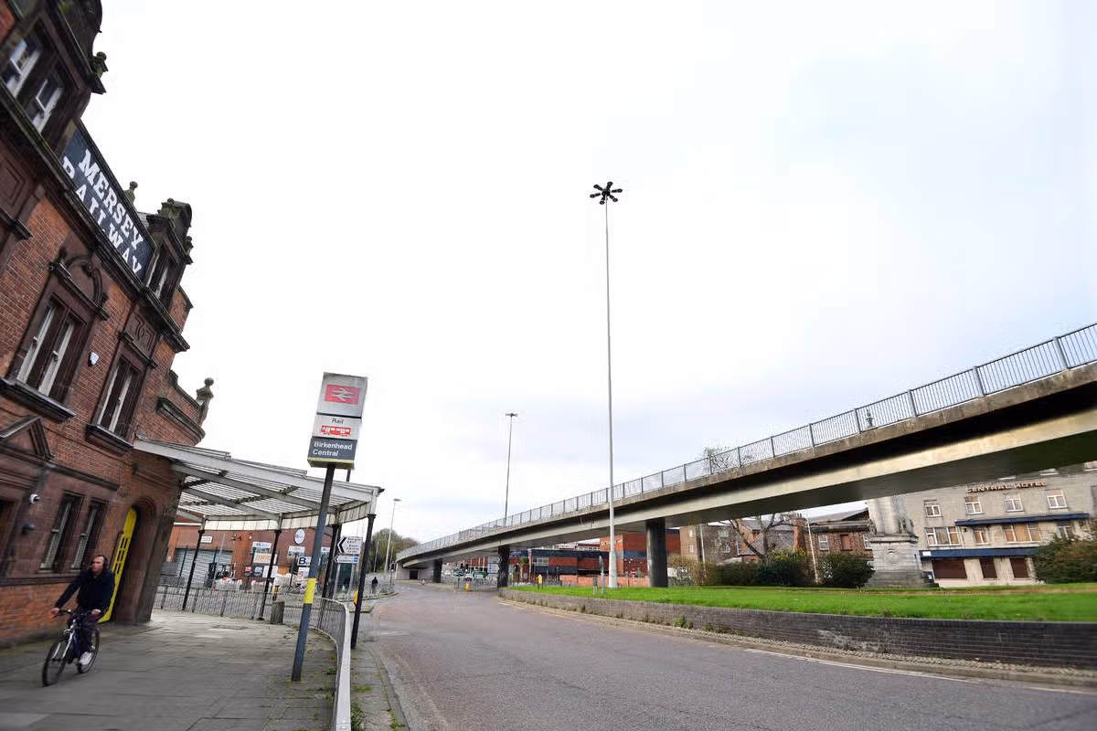 Birkenhead Central Station on Borough Road, with  the former Central Hotel and the flyover to the Birkenhead Tunnel on the right