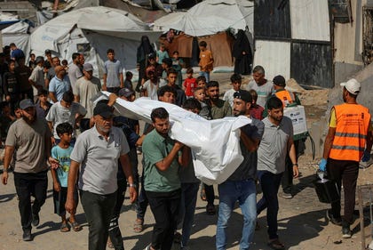 Mourners carry the body of a Palestinian killed in an Israeli army strike on Gaza City's port the previous day, during a funeral in Gaza City on August 19, 2026. Gaza health officials said on August 18, 2026, that an Israeli airstrike killed six people in the port of Gaza City and wounded a dozen more, while the Israeli army said it had targeted several Hamas commanders. (Photo by Omar AL-QATTAA / AFP)