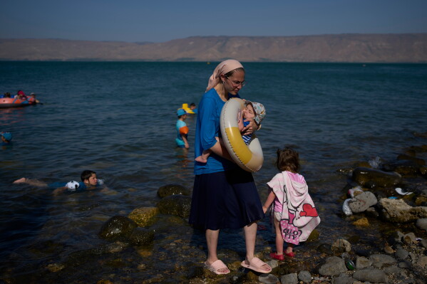 People bathe in the Sea of Galilee in northern Israel, Wednesday, July 29, 2026. (AP Photo/Ohad Zwigenberg)