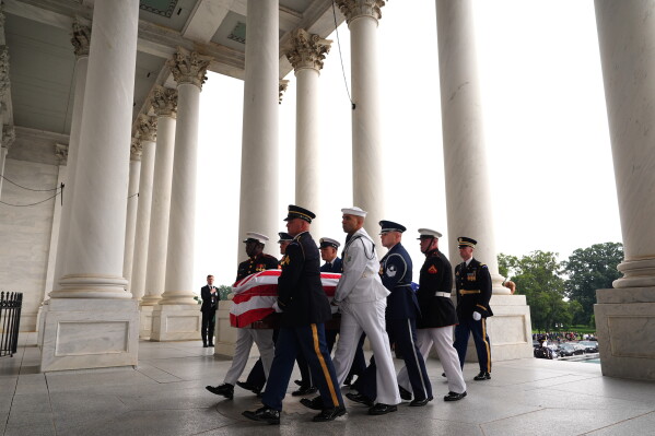 An Armed Forces Body Bearer Team moves the casket of Sen. Lindsey Graham, R-S.C., upon arrival for a Congressional tribute in the Rotunda of the U.S. Capitol, Tuesday, July 28, 2026, in Washington. (AP Photo/Mark Schiefelbein, Pool)