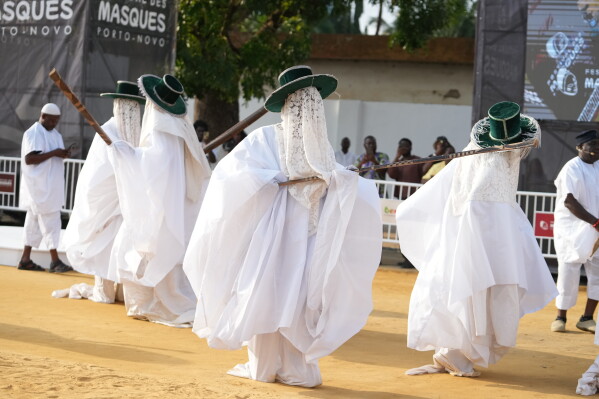 People dressed in costumes perform during the mask festival in Porto-Novo, Benin, Sunday, July 26, 2026. (AP Photo/Sunday Alamba)