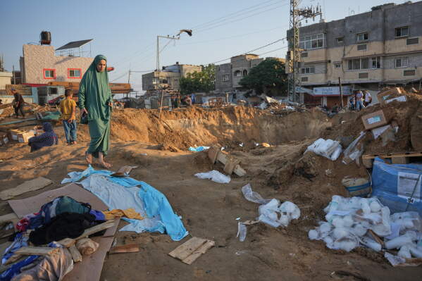 Palestinians inspect the scene of an Israeli airstrike near al-Aqsa Hospital in Deir al-Balah in the central Gaza Strip, Saturday, Aug. 1, 2026. (AP Photo/Abdel Kareem Hana)