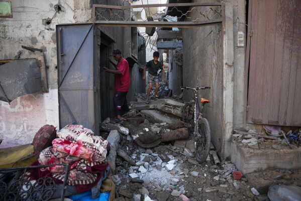 Palestinians inspect the scene of an Israeli airstrike in Nuseirat, central Gaza Strip, Saturday, Aug. 1, 2026. (AP Photo/Abdel Kareem Hana)