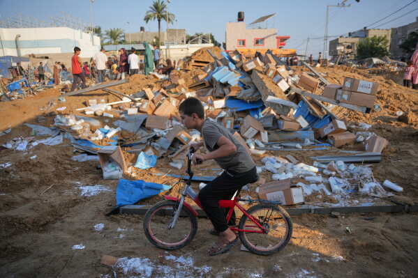 A boy rides a bicycle near the scene of an Israeli airstrike near al-Aqsa Hospital in Deir al-Balah in the central Gaza Strip, Saturday, Aug. 1, 2026. (AP Photo/Abdel Kareem Hana)
