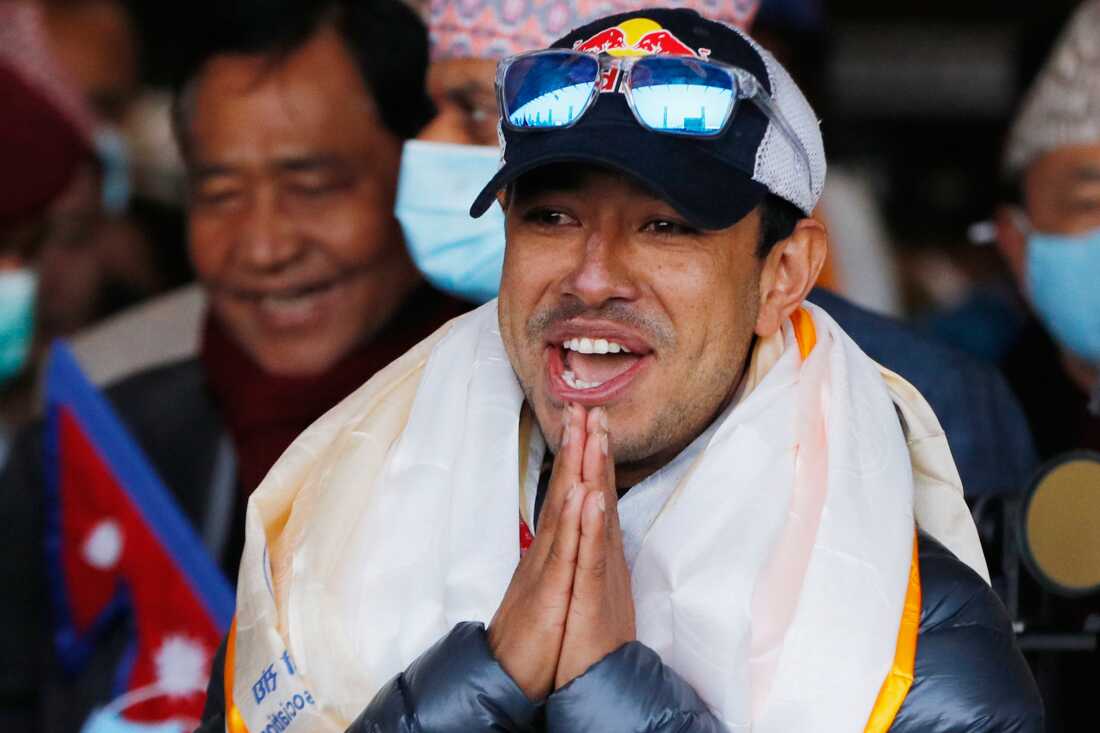 Nirmal Purja, one of the team member of the all-Nepalese mountaineering team that became the first to scale Mount K2 in winter, gestures as the team arrives at Tribhuwan International airport in Kathmandu, Nepal, Jan. 26, 2021.
