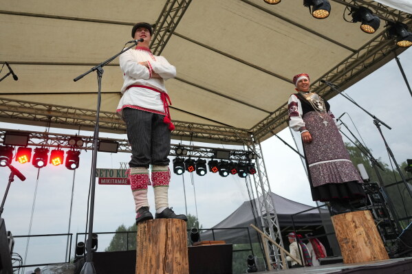 Estonia Seto Kingdom Day Rain Oper, left, and Ingrit Kala stand during elections of the new representative of the Seto community during the annual Seto Kingdom Day in Mikitamäe, south Estonia, Saturday, Aug. 1, 2026. (AP Photo/Sergei Grits)