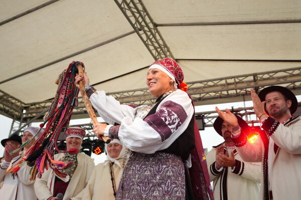 Estonia Seto Kingdom Day Newly elected ülemsootska, Ingrit Kala holds a kiiora, a forked ceremonial branch during the annual Seto Kingdom Day in Mikitamäe, south Estonia, Saturday, Aug. 1, 2026. (AP Photo/Sergei Grits)