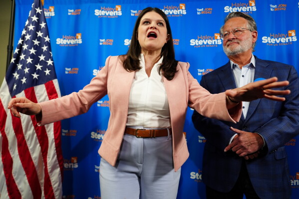 Rep. Haley Stevens, D-Mich., left, a candidate in the Democratic primary for U.S. Senate in Michigan, accompanied by Sen. Gary Peters, D-Mich., speaks during a campaign event at the UA Local Plumbers 98 Union Hall, Sunday, Aug. 2, 2026, in Madison Heights, Mich. (AP Photo/Julia Demaree Nikhinson)