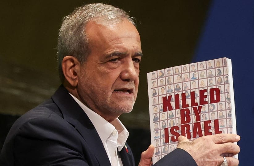 Iran's President Masoud Pezeshkian holds a book as he addresses the 80th United Nations General Assembly (UNGA) at the UN headquarters in New York, US, September 24, 2025