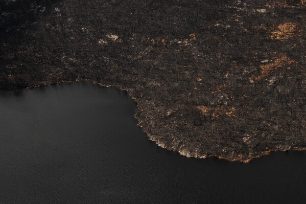 Wildfire damage is visible in the immediate area surrounding Collins First Nation, a small, remote Ojibwa community in northwestern Ontario, July 22, 2026. (Chris Young/The Canadian Press via AP, File)