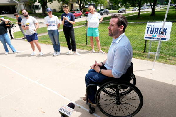 Iowa state Rep. Josh Turek, a Democratic candidate for U.S. Senate, talks to supporters before a neighborhood canvassing event, May 31, 2026, in Waukee, Iowa. (AP Photo/Charlie Neibergall, File)