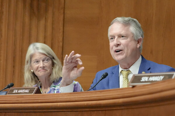 Sen. Roger Marshall, R-Kan., asks a question as Sen. Lisa Murkowski, R-Alaska, reacts during a Senate Health Education Labor and Pension committee confirmation hearing for Keith Sonderling to be Labor Secretary, on Capitol Hill, Thursday, July 16, 2026, in Washington. (AP Photo/Mariam Zuhaib)