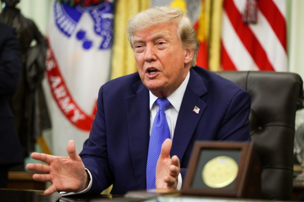 President Donald Trump speaks during an event in the Oval Office.