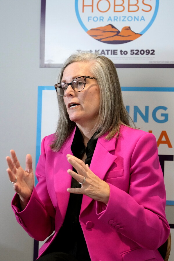 Arizona Democratic Gov. Katie Hobbs, right, talks about her running mate for Lieutenant Governor John Giles, the former Republican Mesa, Ariz., mayor, Monday, Aug. 10, 2026, in Phoenix. (AP Photo/Ross D. Franklin)