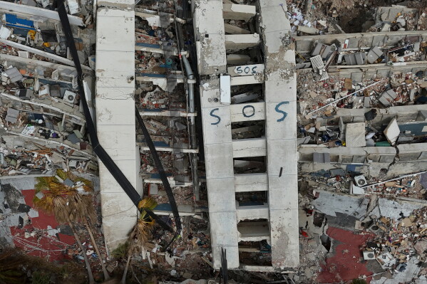 A building damaged during the earthquakes is marked with "S.O.S." painted stands in La Guaira, Venezuela, July 2, 2026. (AP Photo/Matias Delacroix, File)