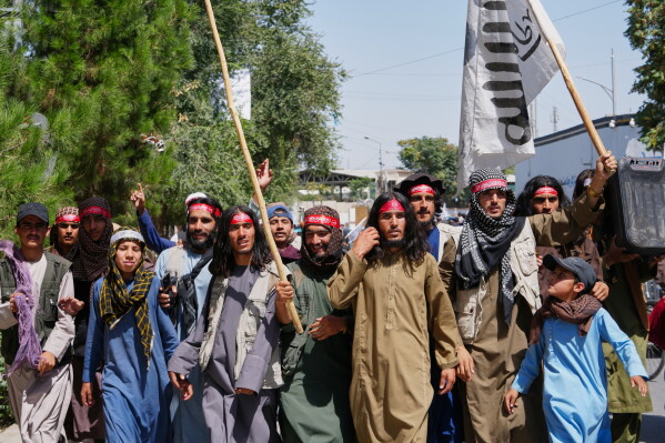 Taliban government supporters march during celebrations marking the fifth anniversary of the U.S. withdrawal from Afghanistan and the Taliban's return to power, in Kabul, Afghanistan, Saturday, Aug. 15, 2026. (AP Photo/Siddiqullah Alizai)