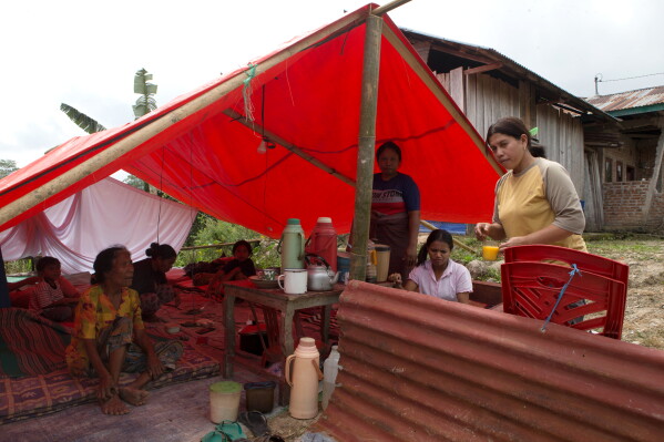 People stay in a makeshift tent amid fears of aftershocks, following an earthquake in Lembor, East Nusa Tenggara province, Indonesia, Sunday, Aug. 16, 2026. (AP Photo/Firdia Lisnawati)