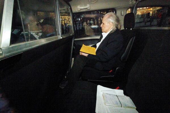 Former fashion executive Peter Nygard, seen through a police vehicle window, arrives at a courthouse in Toronto, Oct. 3, 2023. (Cole Burston/The Canadian Press via AP, File)