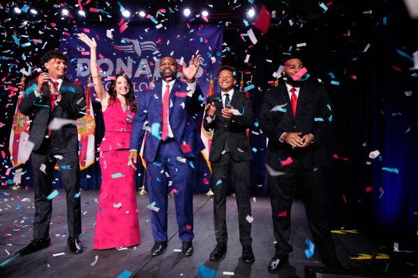 Florida Republican gubernatorial candidate Byron Donalds, center, waves next to his wife Erika, while standing on stage with their children Darin, left, Damon, second from left, and Mason during at a primary election party Tuesday, Aug. 18, 2026, in Orlando, Fla. (AP Photo/John Raoux)