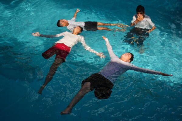Palestinian children who lost their legs after being injured during the war between Israel and Hamas receive swimming training from the Heal Palestine organization at a pool in Khan Younis, Gaza Strip, Wednesday, Aug. 19, 2026. (AP Photo/Abdel Kareem Hana)
