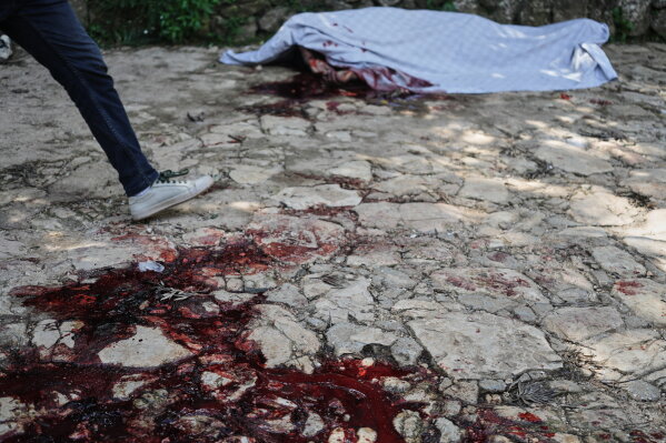 Blood stains the ground left behind by the victim of a gang attack in the Kenscoff neighborhood of Port-au-Prince, Haiti, Monday, Aug. 24, 2026. (AP Photo/Odelyn Joseph)