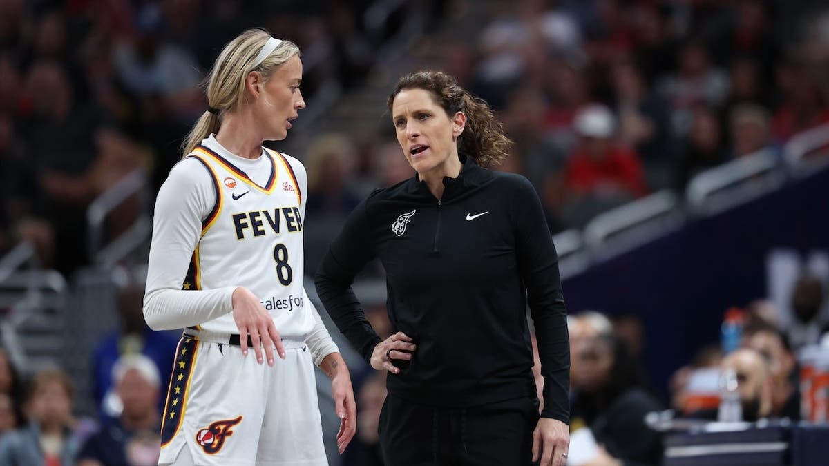 Sophie Cunningham and head coach Stephanie White stand during an Indiana Fever game.