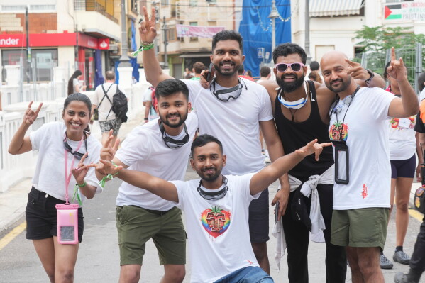 Revelers from India pose for a picture ahead of the annual "Tomatina" tomato fight fiesta, in the village of Bunol near Valencia, Spain, Wednesday, Aug. 26, 2026. (AP Photo/Alberto Saiz)