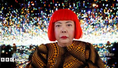 Japanese artist Yayoi Kusama poses for a photograph inside her Infinity Mirrored Room installation titled "The Souls of Millions of Light Years Away" during a media preview of her new exhibition at the David Zwirner gallery in New York, U.S.