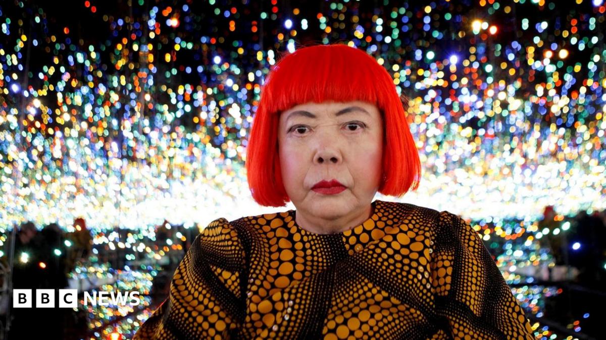 Japanese artist Yayoi Kusama poses for a photograph inside her Infinity Mirrored Room installation titled "The Souls of Millions of Light Years Away" during a media preview of her new exhibition at the David Zwirner gallery in New York, U.S.