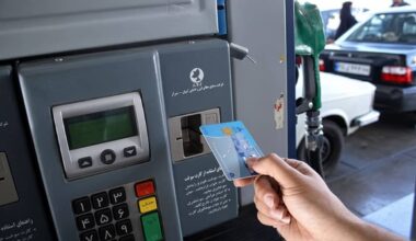 A driver inserts a smart fuel rationing card into the reader at a gas station in Shiraz, southern Iran
