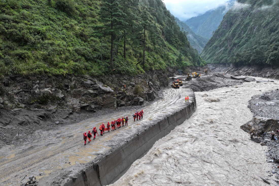 A drone view of firefighters conducting search and rescue operations at a damaged road leading to Gyirong Port after a mudslide, in Gyirong county, Shigatse, Tibet Autonomous Region, China August 28, 2026.