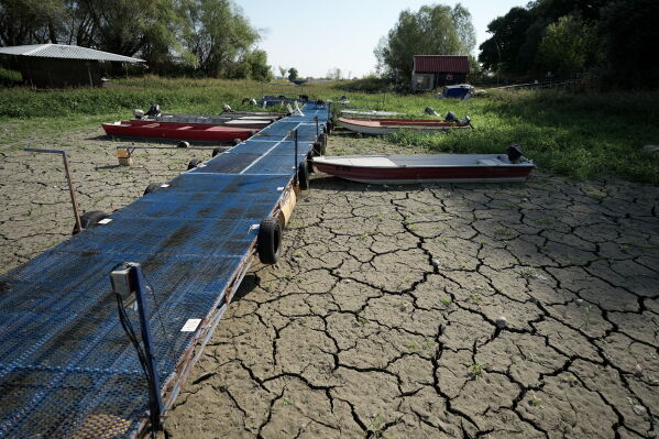 Boats sit on dry ground as water levels have dropped on the Danube River in Petrovaradin, Serbia, Tuesday, Aug. 25, 2026. (AP Photo/Darko Vojinovic)