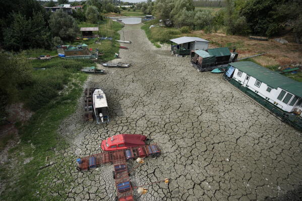 Boats sit on dry ground as water levels have dropped on the Danube River in Petrovaradin, Serbia, Tuesday, Aug. 25, 2026. (AP Photo/Darko Vojinovic)