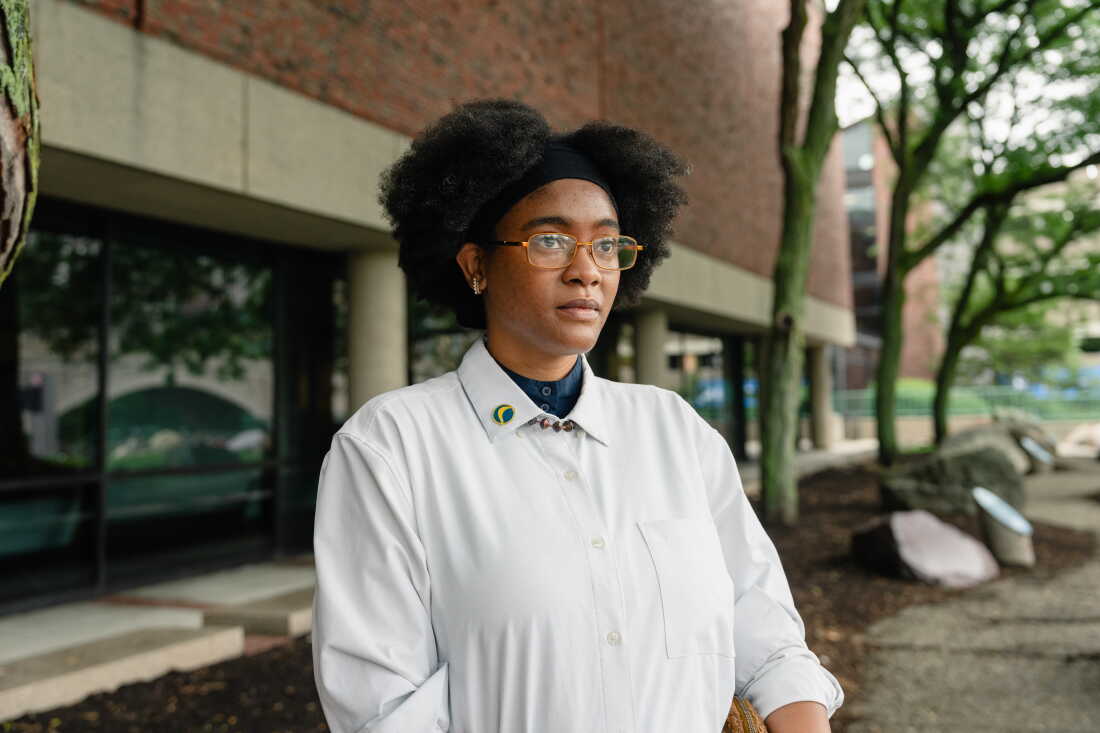 Netia McCray stands outside the Museum of Science, where she runs a STEM educational program for teens, in Boston, Mass. McCray, who developed long COVID near the beginning of the pandemic, was volunteering on a federal advisory committee on the disease before it was terminated.