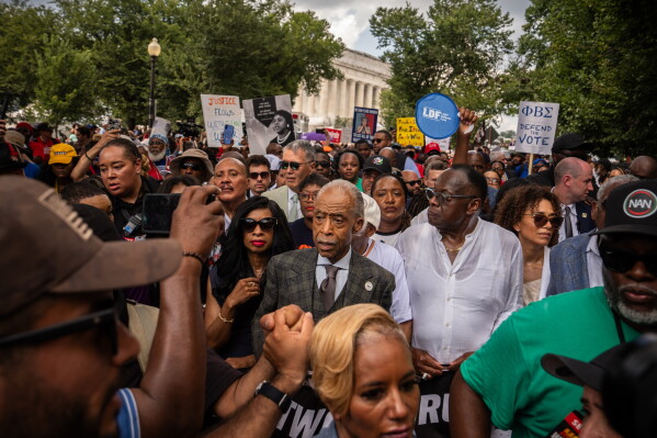 Rev. Al Sharpton, center, and other activists walk from the Lincoln Memorial to the Martin Luther King, Jr. Memorial during the March on Washington, Friday, Aug. 28, 2026, in Washington. (AP Photo/Julia Demaree Nikhinson)