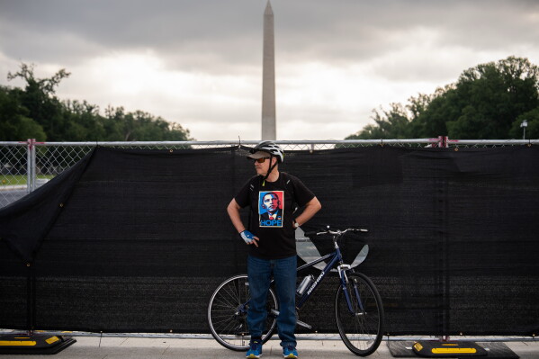 A demonstrator wears a shirt depicting former President Barack Obama in front of fencing surrounding the Lincoln Memorial Reflecting Pool, during the March on Washington, Friday, Aug. 28, 2026, in Washington. (AP Photo/Julia Demaree Nikhinson)