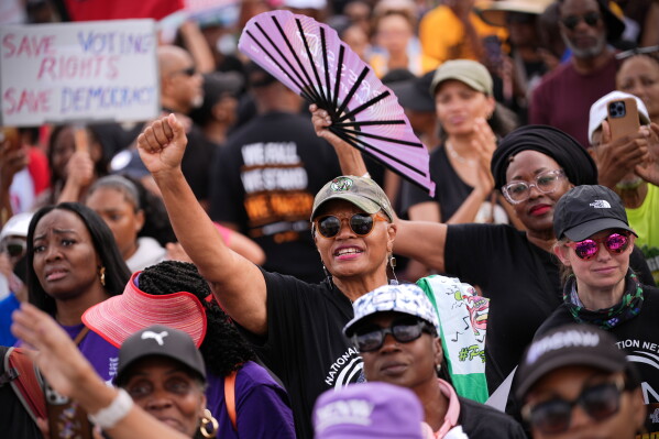 Demonstrators listen to speakers during the March on Washington, Friday, Aug. 28, 2026, near the Lincoln Memorial in Washington. (AP Photo/Julia Demaree Nikhinson)