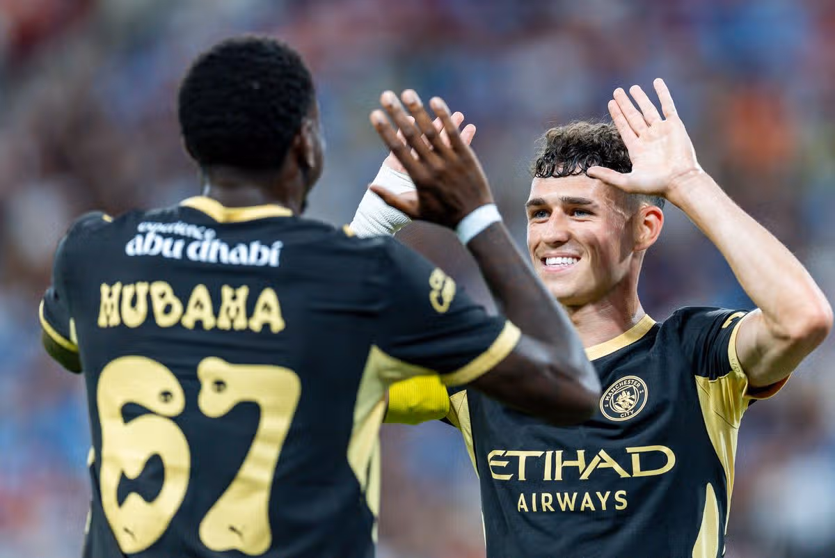 HONG KONG, CHINA - AUGUST 1: Divin Mubama of Manchester City (L) celebrates after scoring his goal with Phil Foden of Manchester City (R) during the Manchester City v Inter Milan - Pre-Season Friendly at Kai Tak Stadium on August 1, 2026 in Hong Kong, China. (Photo by Yu Chun Christopher Wong/Eurasia Sport Images/Getty Images)