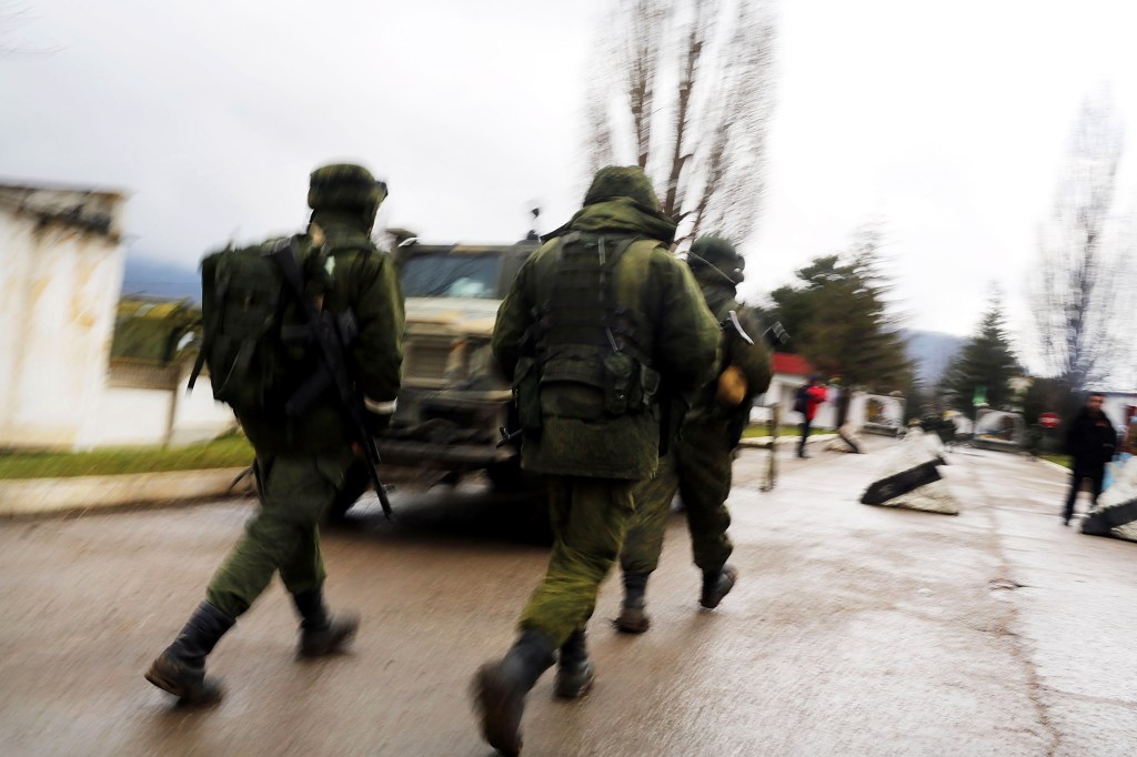 Armed soldiers without identifying insignia keep guard outside of a Ukrainian military base in the town of Perevevalne near the Crimean city of Simferopol on March 16, 2014 in Perevevalne, Ukraine.
